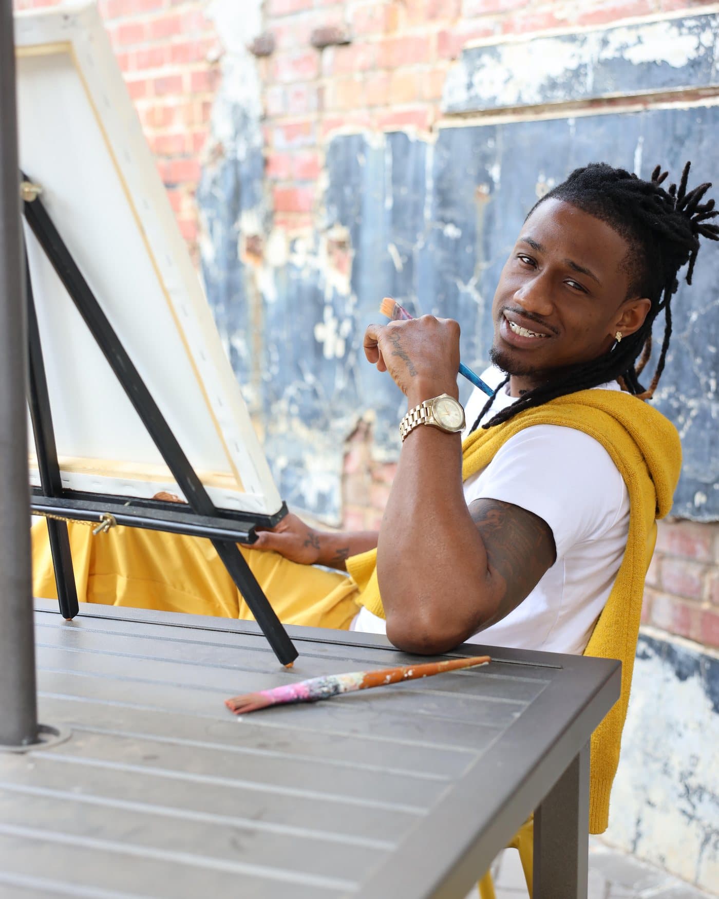 Marley, the artist behind Natural Art Studios, at his easel in Charlotte